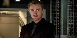 The Flash Tom Felton scowls in a server room