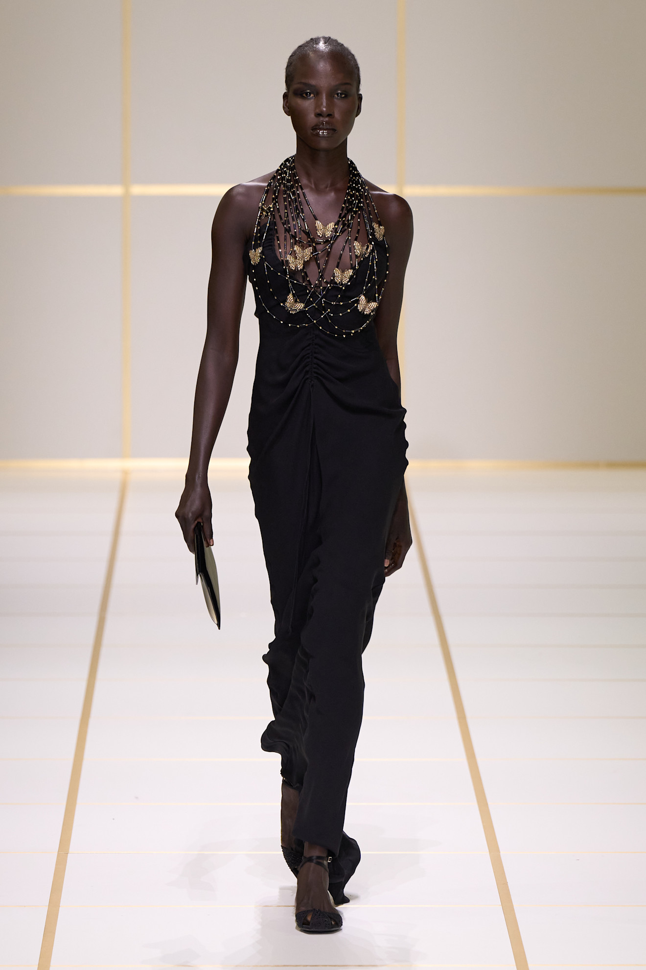 a model walks the giorgio armani s/s 27 runway.