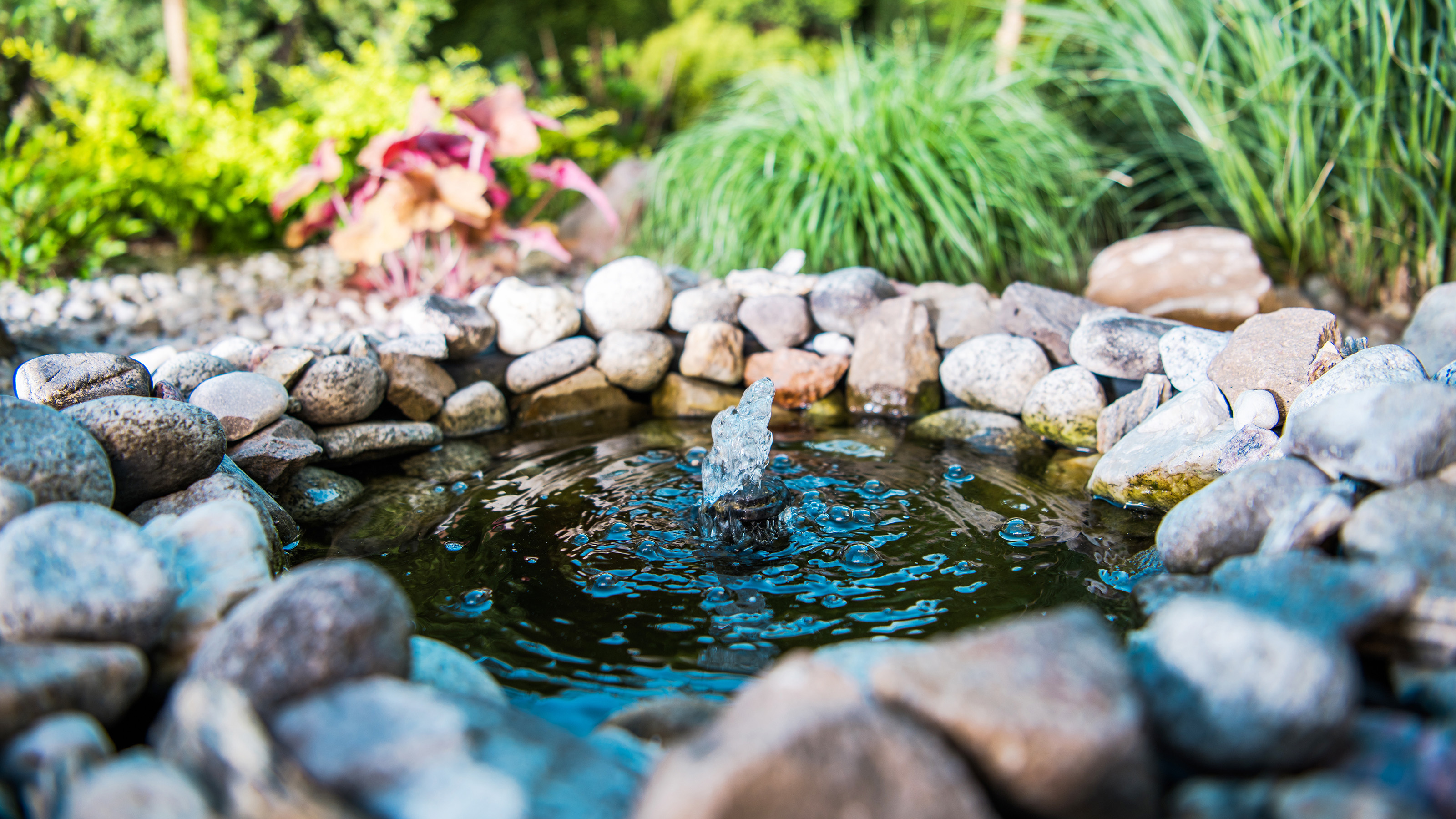 small garden pond ideas with fountain and rock edges in garden