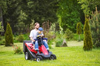 ride on lawn mower on green and thick lawn