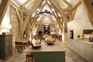 barn conversion with lighting in kitchen and beams 