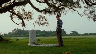 Forrest Gump stands at Jenny's grave on a sunny day in Forrest Gump