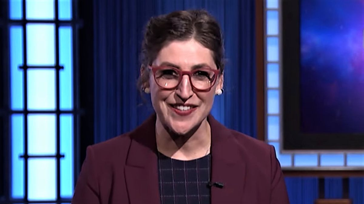 Mayim Bialik smiling on Jeopardy stage