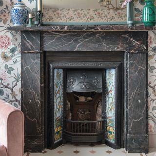 marble fireplace with decorative panelling and patterned tiled hearth original style
