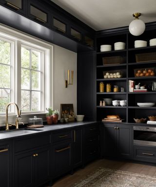 Dark kitchen cabinets in a pantry designed by Shea McGee