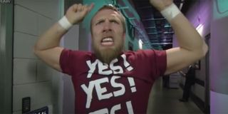 Daniel Bryan doing the Yes chant with his arms raised.