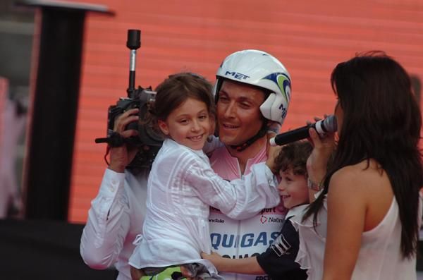 Ivan Basso (Liquigas-Doimo) holds one of his children as he savors his Giro d'Italia win