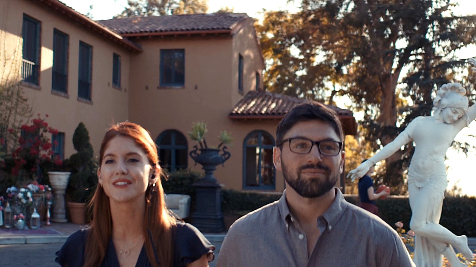 Two of the fictional reality show's producers stand in front of a mansion in The Final Rose.