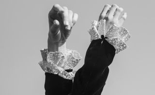 Close-up of two frill cuffs around the top of each hand.