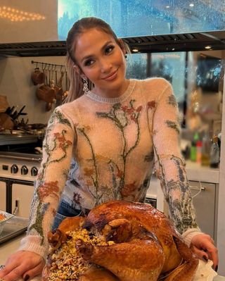 jennifer lopez wears a cherry blossom sweater on thanksgiving 2024