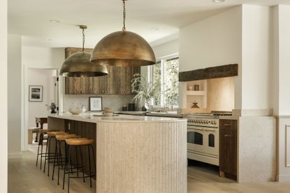 An neutral kitchen with dark wood kitchen cabinets