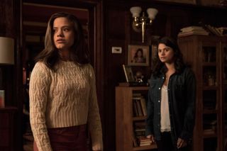 two women in the charmed reboot stand in an old home and look scared