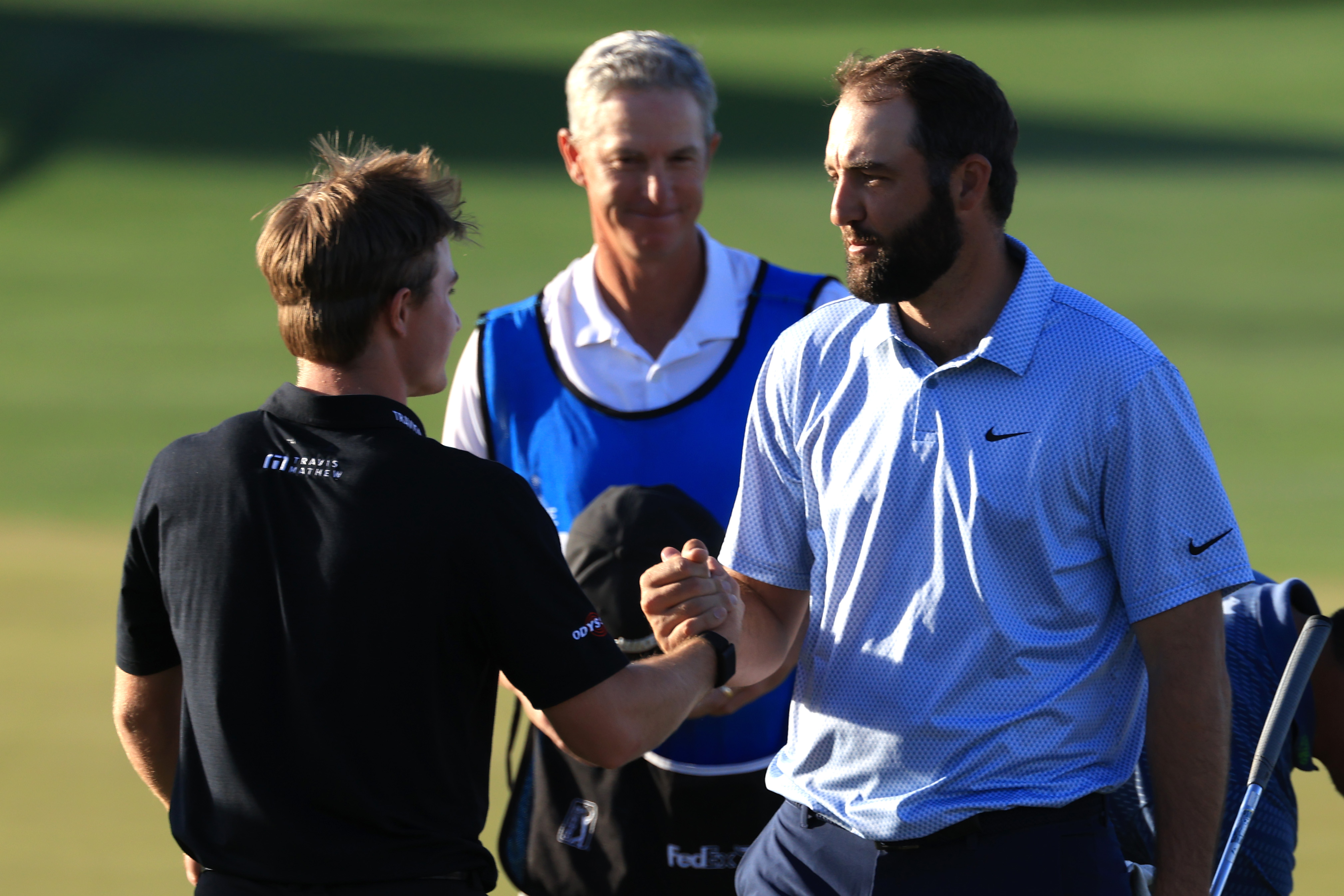 Blades Brown and Scottie Scheffler shake hands after finishing the American Express PGA Tour event
