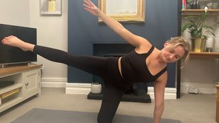 Woman doing a gate pose with her leg lifted in the air.