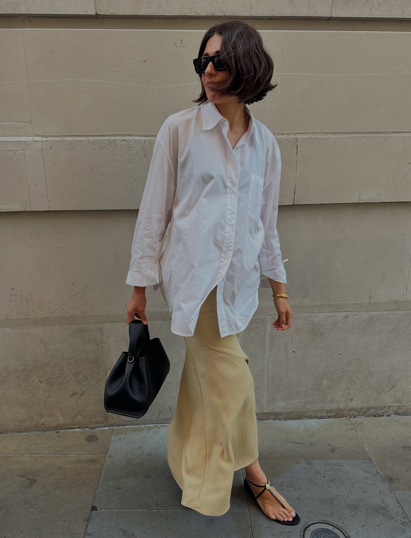 Influencer Lucy Alston wearing an anti-trend outfit of oxford shirt, maxi skirt and sandals