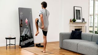 Man exercising in front of Vaha X fitness mirror