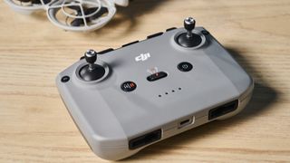 An RC-N3 controller sitting next to a gray DJI Neo drone