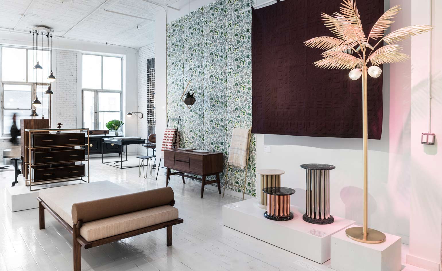 daybed stands in front of a dark wall hanging is by Meg Callahan. The 'Palmyra' palm tree lamp