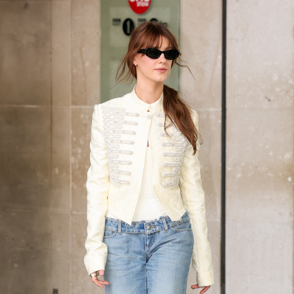 An image of Daisy Edgar-Jones wearing a Napoleon jacket with stovepipe jeans. 