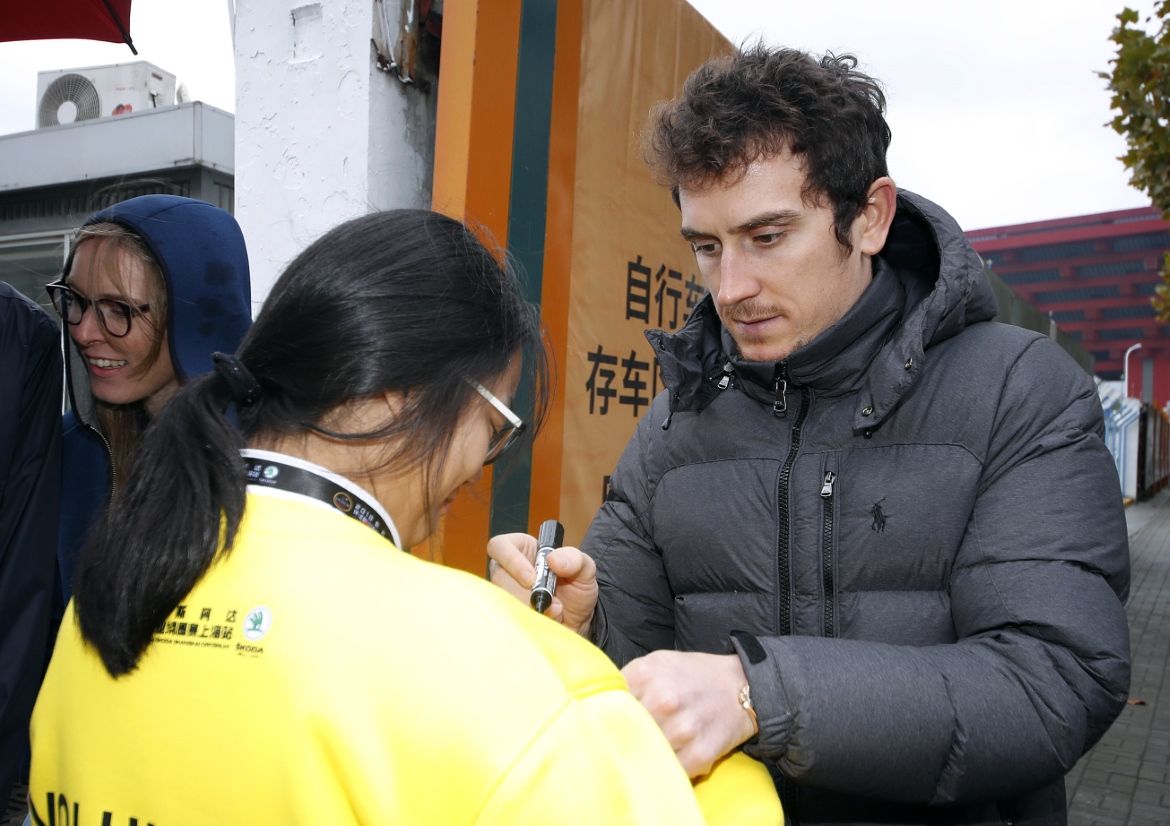 Geraint Thomas signs an autograph for a fan