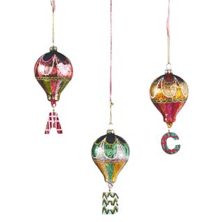 Three Christmas hot air balloon decorations that have an A, B, and C hanging off them