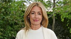 Cat Deeley is pictured wearing a white top and cardigan, with a glossy lip look, whilst attending The Boodles Garden designed by Catherine MacDonald of Landform Consultants at the RHS Chelsea Flower Show 2026 on May 18, 2026 in London, England.
