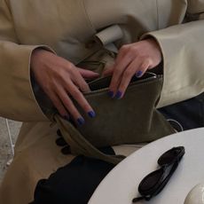 Creator @mimixn reaching into a suede makeup bag
