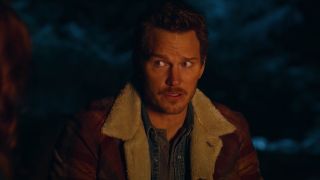 Chris Pratt as Owen Grady next to campfire in Jurassic World Dominion