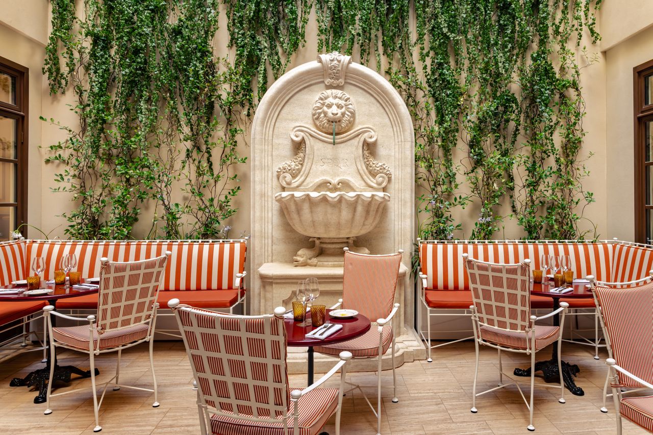 A maximalist hotel features contrasting textures, textiles, and shapes for a striking and retro-fueled effect.