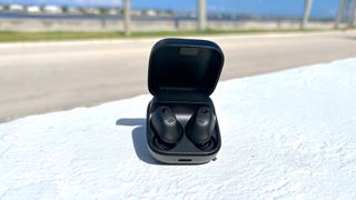 Sennheiser Accentum True Wireless Earbuds on a white wall outside