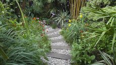 garden sleeper ideas used as path with gravel and plants either side