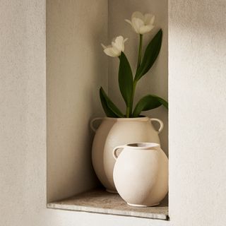 Beige vase with handles with flowers