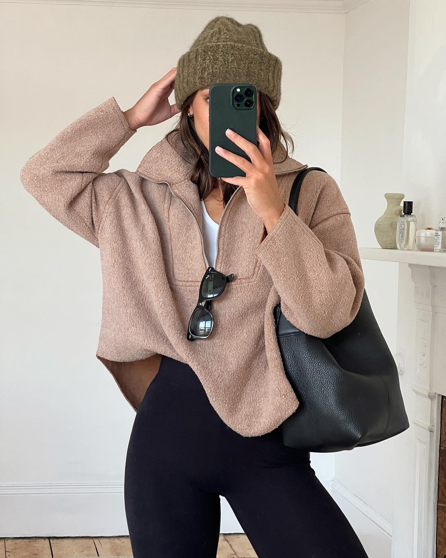 Influencer wearing quarter-zip-sweater outfit.
