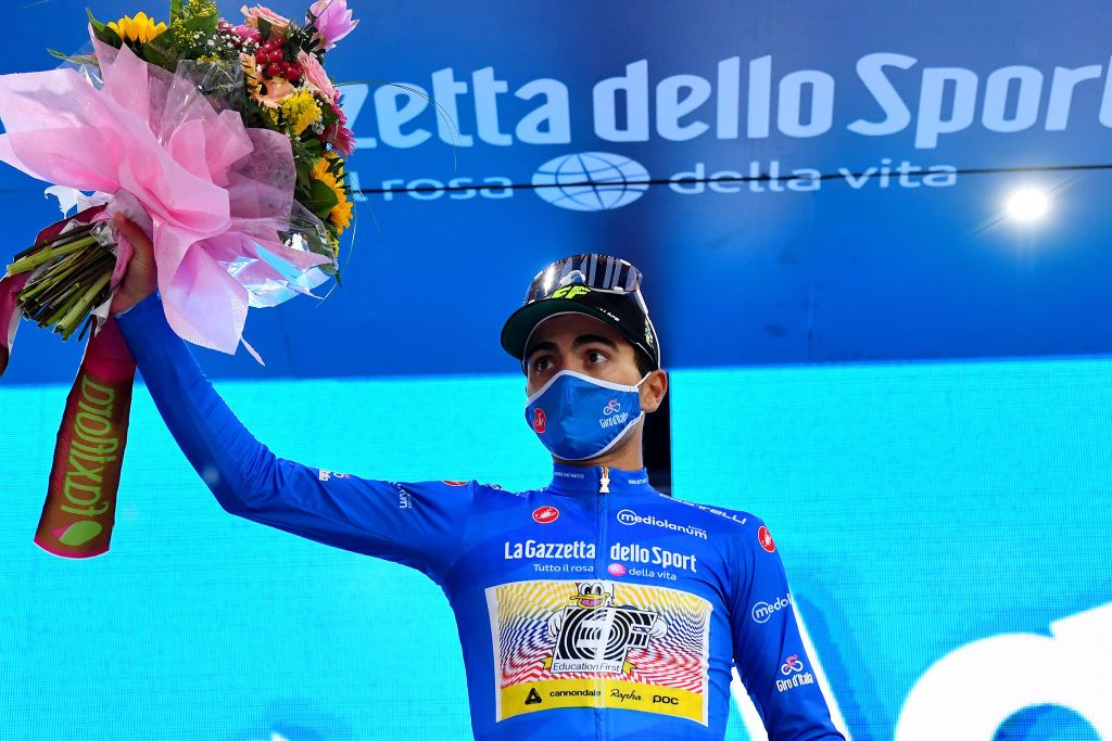 CESENATICO ITALY OCTOBER 15 Podium Ruben Guerreiro of Portugal and Team EF Pro Cycling Blue Mountain Jersey Celebration Flowers Mask Covid safety measures during the 103rd Giro dItalia 2020 Stage Twelve a 204km stage from Cesenatico to Cesenatico girodiitalia Giro on October 15 2020 in Cesenatico Italy Photo by Stuart FranklinGetty Images