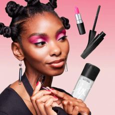 A model wearing MAC makeup with a variety of MAC products floating around her.