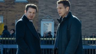 L-R: Jeremy Renner as Mike McLusky and Taylor Handley as Kyle McLusky facing each other while both looking at what it to their left.