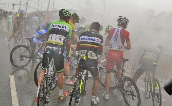 After yet another hot day, the peloton are cooled down by the fire department