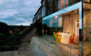 minimalist glass box extension with view and dining table