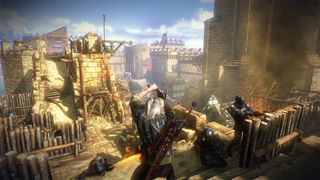 Geralt weilds a sword atop a castle wall in The Witcher 2