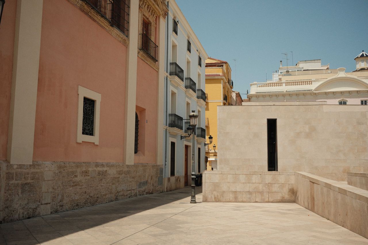 A street with pastel colored buildings on a street in Valencia Spain