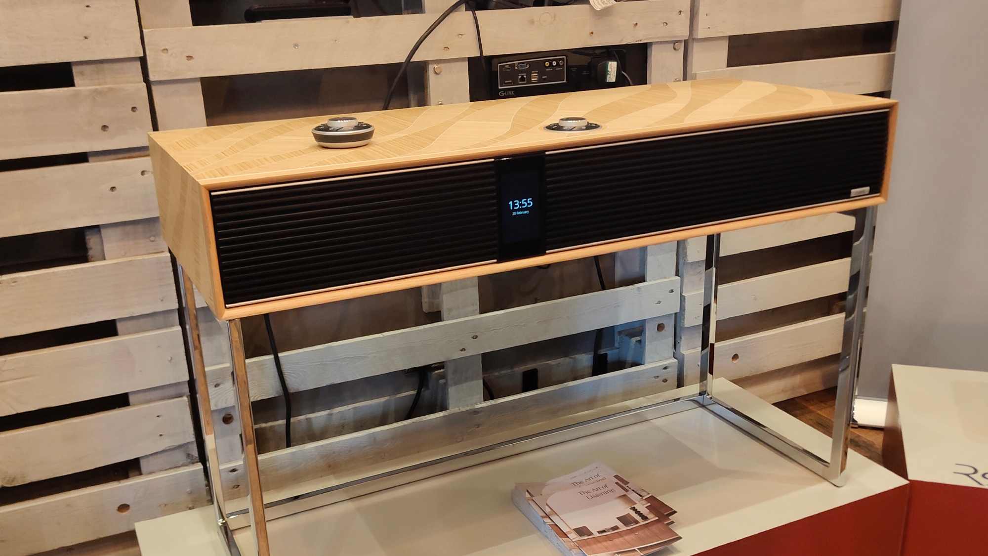 The Ruark R810 MIE standing before a wooden wall.