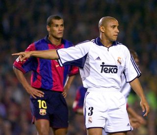 Roberto Carlos in action for Real Madrid against Barcelona and Brazil team-mate Rivaldo in October 2000.