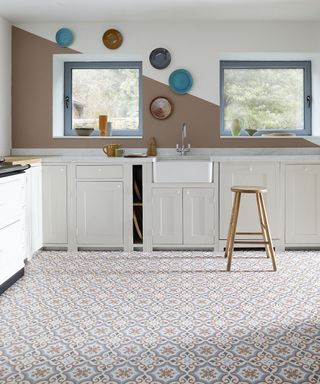 A kitchen with a vinyl tiled floor patterned in a Mediterranean style