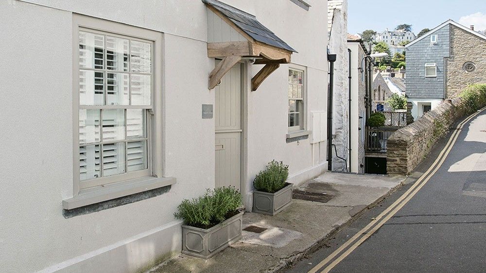 white wall with road and window with shrubs