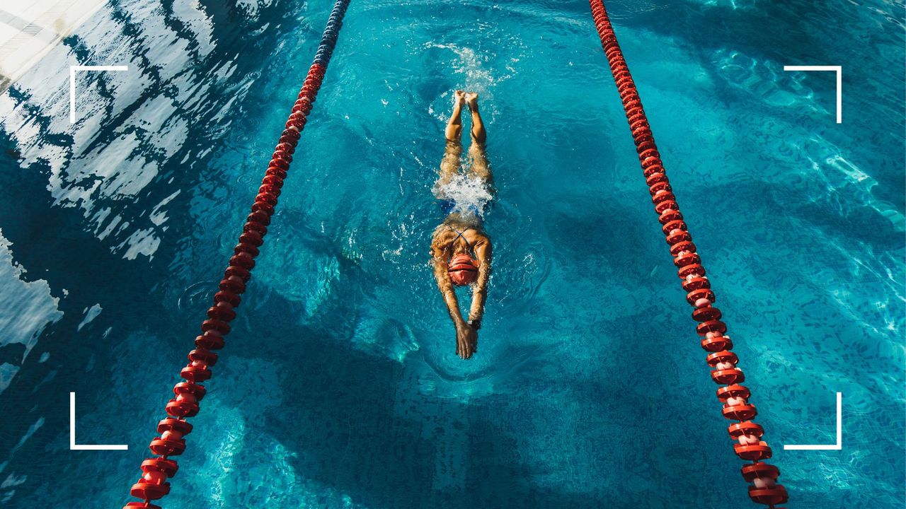 Woman doing swimming as a workout for beginners, swimming lengths down a pool in swimsuit, goggles, and hat