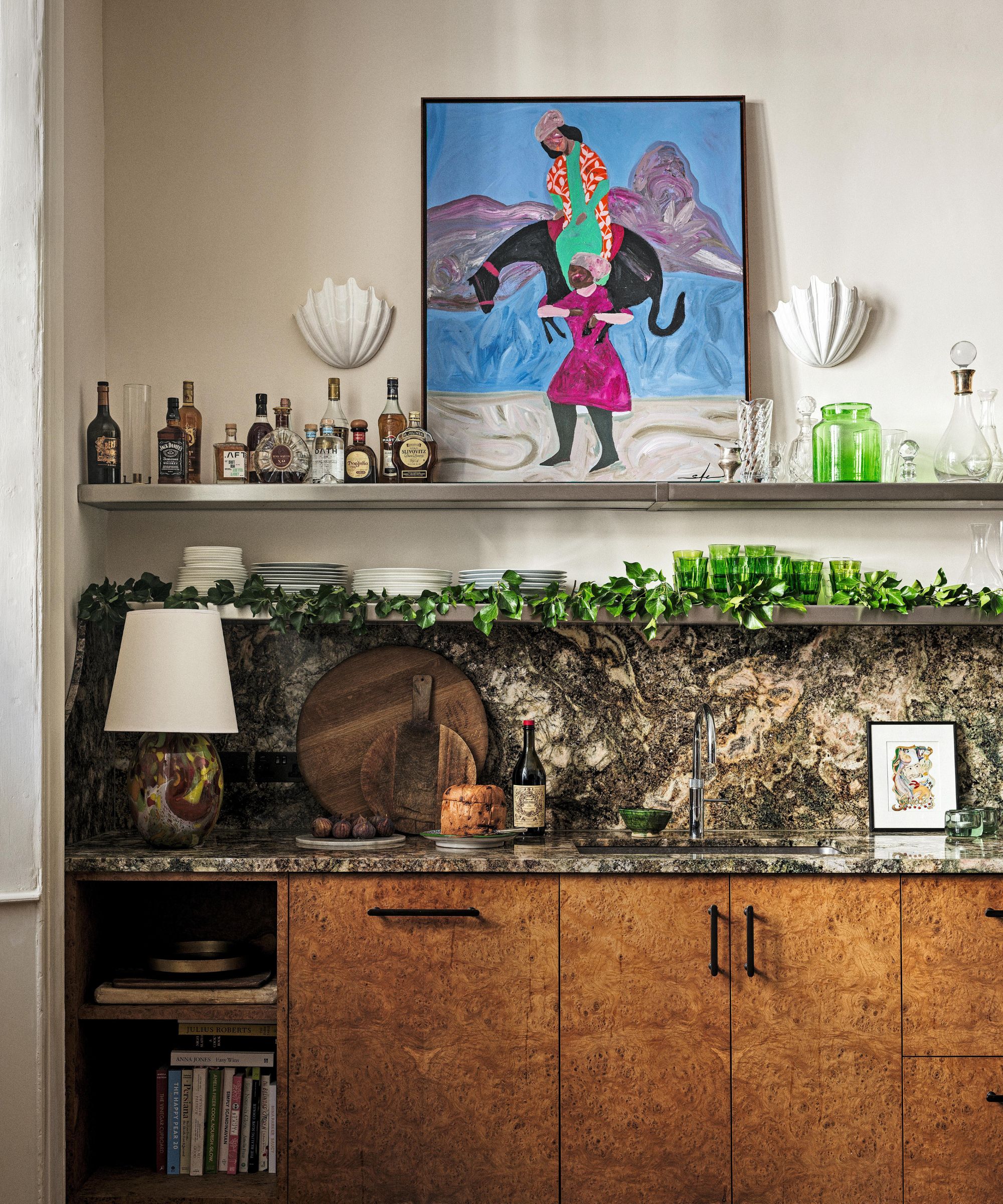 Kitchen with burl wood cabinets and a gray marble splashback with shelving above