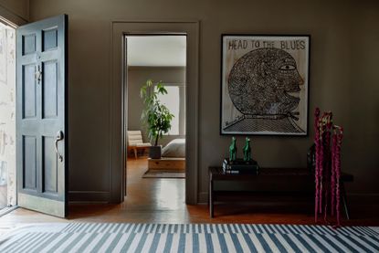 a dark brown entryway with wall art