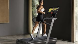 Woman running on Technogym Run treadmill