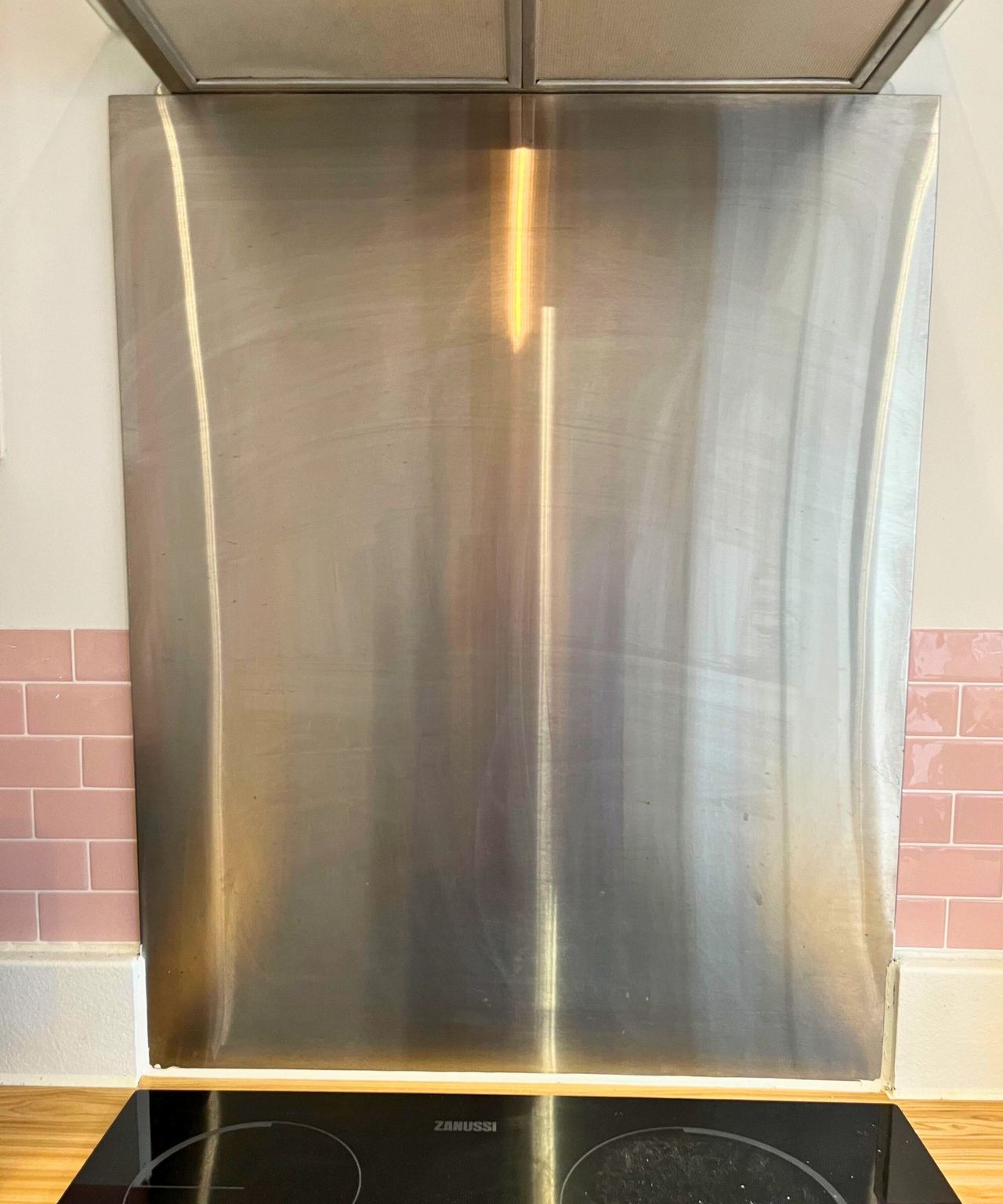 My streaky stainless steel backsplash before cleaning it with my essential oil cleaning spray.