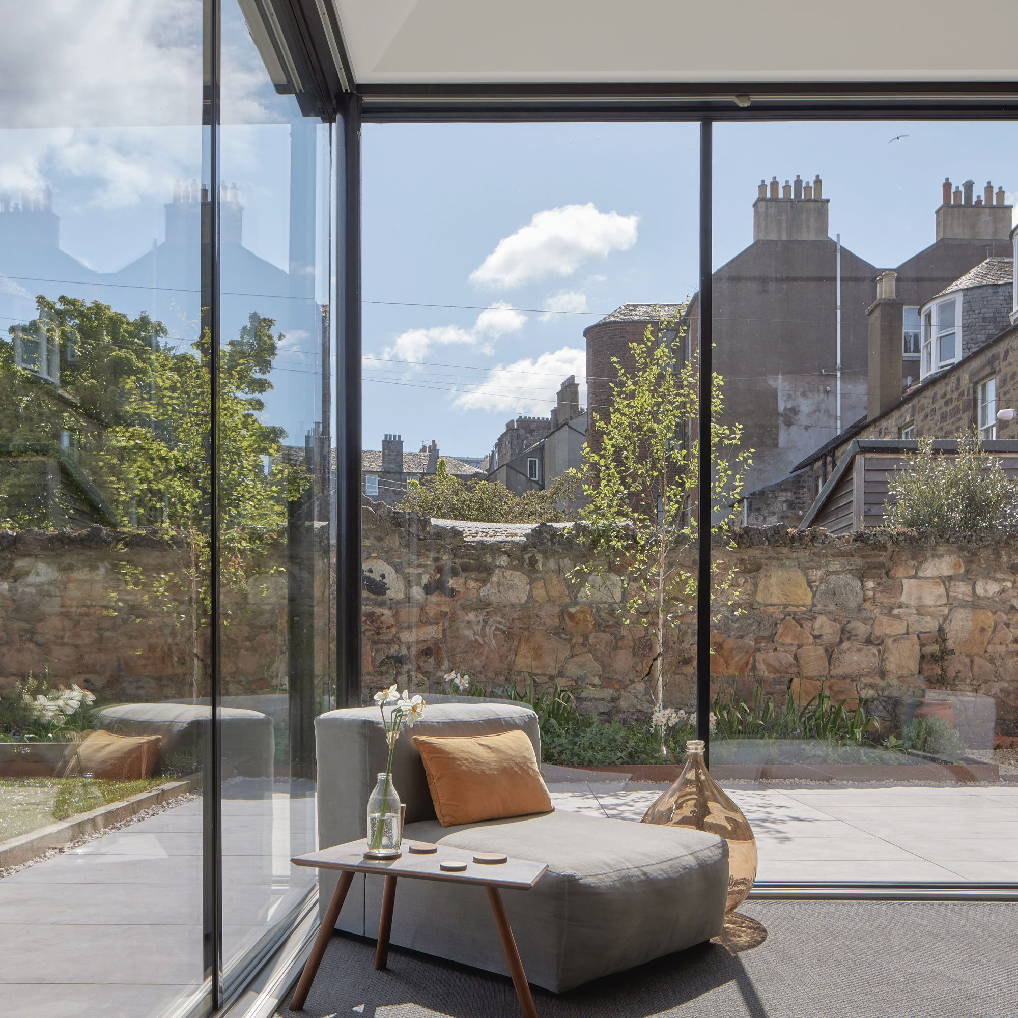 a sunny corner glazed extension with an armchair